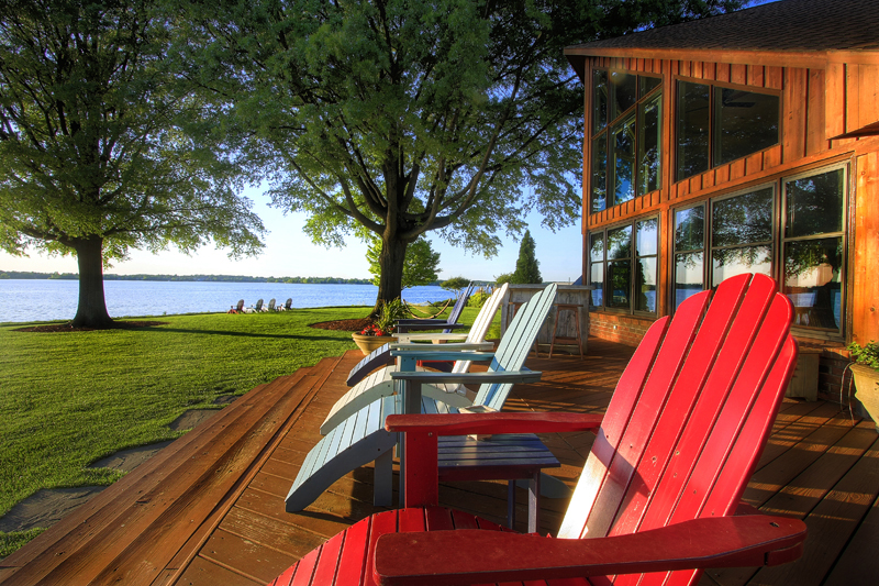 Lakefront deck with red chairs